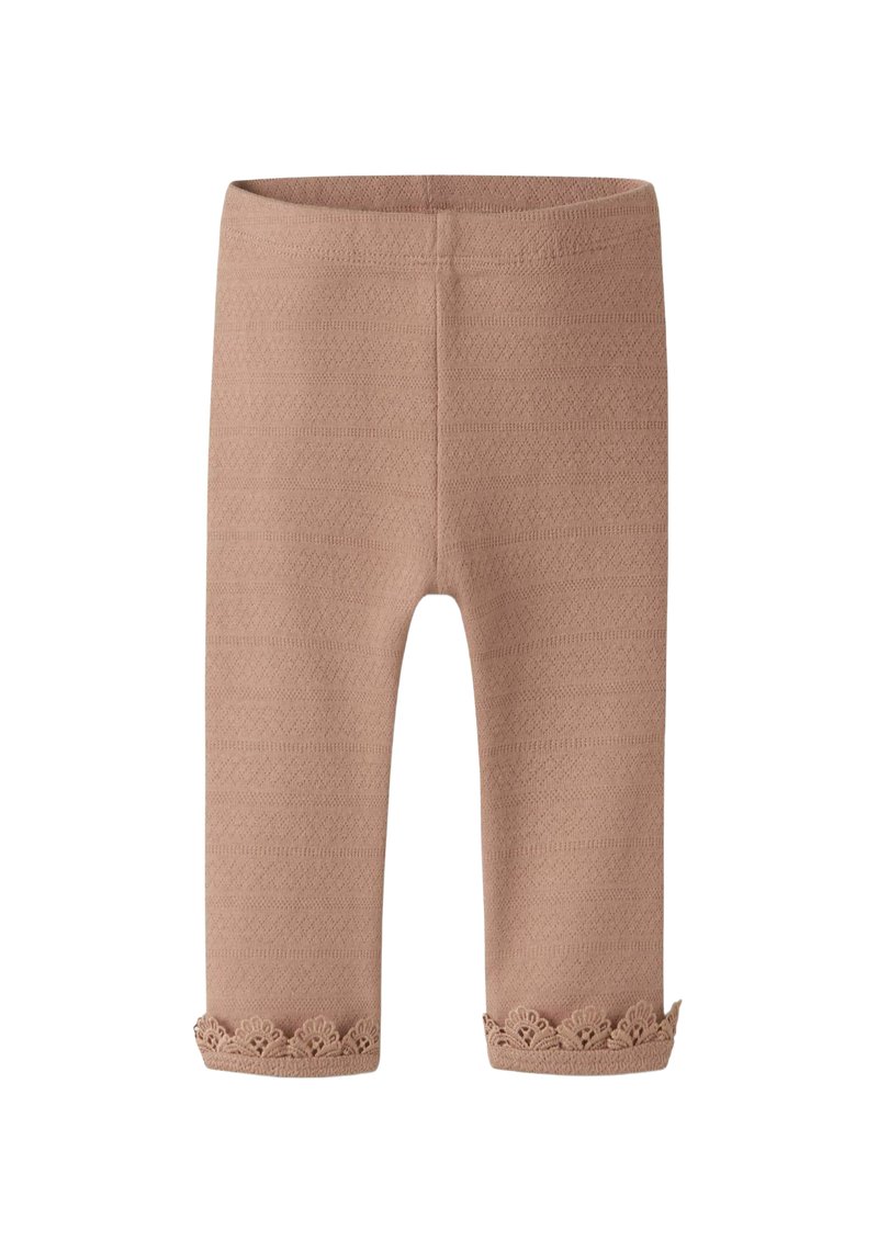 Beige legging met een gestructureerd patroon, voorzien van een kanten rand bij de zoom. Gemaakt van zacht, rekbaar materiaal, ontworpen voor comfort en pasvorm.