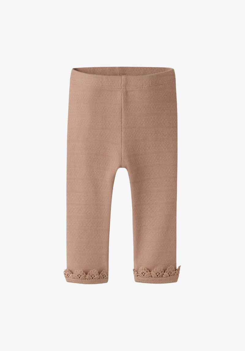 Leggings beige avec un motif texturé, ornés d'un bord en dentelle à l'ourlet. Fabriqués en matériau doux et extensible, conçus pour le confort et un bon ajustement.