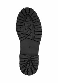 Black rubber boot sole with a pronounced tread pattern, featuring deep grooves and angular shapes for traction. Size marked as 37.