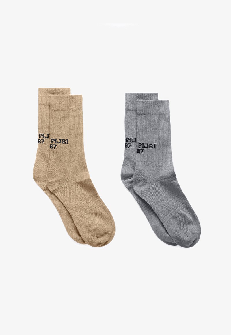 Two pairs of mid-calf socks, one beige and one gray, each with "PIJRI 87" printed near the top in black text.