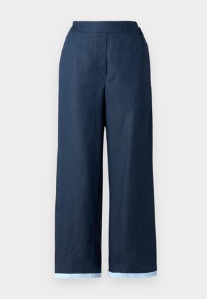 Marineblå vide bukser lavet af linned, med elastisk talje og kontrasterende lys blå kant ved bunden. Glat tekstur.