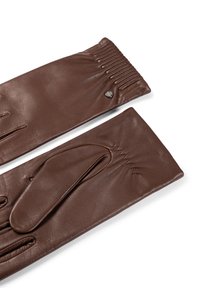 Pair of long brown leather gloves with gathered elastic at wrists and a small round metal logo detail on one glove.