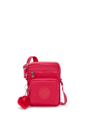 Borsa a tracolla rossa in nylon con cinturino regolabile, due scomparti con zip e badge circolare con logo. Include un portachiavi a forma di scimmietta soffice.
