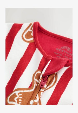 Žvýkací overal pro miminka s červenými a bílými pruhy, s kolečkovým výstřihem a designem perníkového mužíčka. Vyrobeno z jemné bavlny.