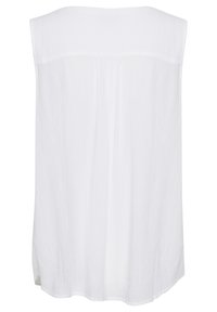 Top sans manches blanc avec une texture lisse, coupe ample et ourlet droit. Le design comprend un détail de couture dans le dos.