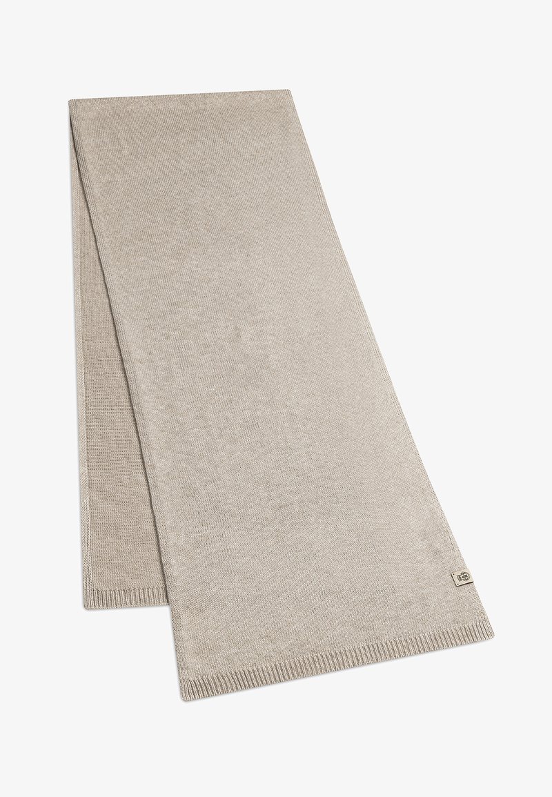 Beige woven scarf with a smooth texture, rectangular shape, and subtle ribbed edges. Features a small logo tag on one corner.
