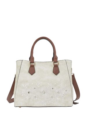 Beige handbag with brown handles and strap, featuring embossed floral design and round cut-out details on front panel.