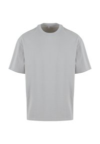 T-shirt en coton gris clair uni à manches courtes, col rond et étiquette de taille moyenne visible à l'intérieur du col.