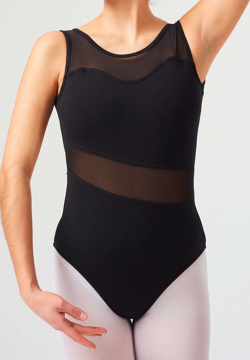 Body noir avec des détails en mesh aux épaules et à la taille. Présente une coupe ajustée et une jambe haute. Modèle portant des collants clairs.
