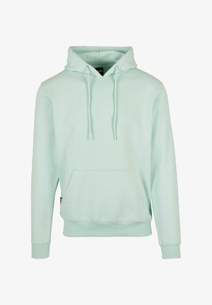 Tirkizno zeleni dukserica od mekanog materijala, s kenguruvim džepom, podešivim trakama i rebrastim rukavima i porubom. Jednostavan dizajn.