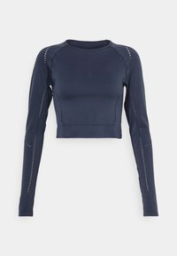 Tengerészkék, hosszú ujjú, croptop, rugalmas anyagból készült, díszes perforációkkal az ujjak mentén és az oldals seams-nél. Kerek nyakkivágás, testhez simuló fazon.