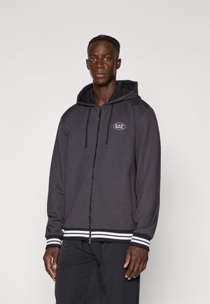 Hooded zip sweatshirt in dark gray fabric with white stripe accents on cuffs and hem, featuring a logo on the chest and side pockets.