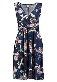 Blumen-Wickeldress aus glattem Stoff. Marineblauer Hintergrund mit pinken und grünen Blumen. V-Ausschnitt und taillierter Detail. Rock bis zum Knie.