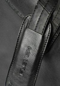 Bolso de cuero negro con superficie texturizada, que cuenta con una correa ancha y un detalle de marca en relieve. Acabado suave con costuras precisas.