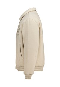 Beige fleece jacket with a relaxed fit, featuring a collar, side pockets, and ribbed cuffs. Includes a decorative logo on the front.