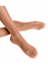 Collants avec pieds peignés d'une teinte beige clair, présentant une texture lisse et une finition semi-opaque, avec des bouts renforcés et un ajustement extensible et confortable.
