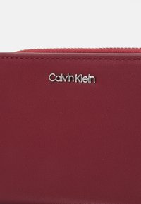 Calvin Klein MUST MEDIUM ZIP AROUND WALLET - Plånbok - biking red