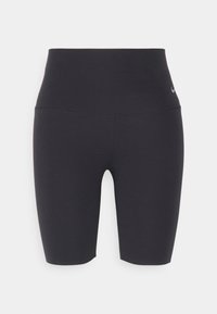Short cycliste noir taille haute sans couture avec un petit logo Nike sur la hanche gauche, présenté sur un fond clair uni.