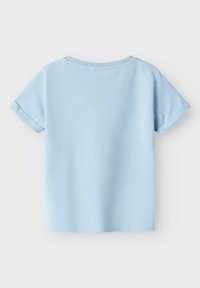 Camiseta de corte corto azul claro con mangas cortas y escote redondeado, fabricada en un suave tejido de algodón y con puños enrollados. Diseño simple y limpio sin gráficos.