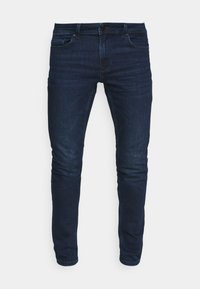 Mörkblå denimjeans med slim fit. Har fem fickor, knappgylf och subtil blekning på låren. Mjuk textur, rent design.
