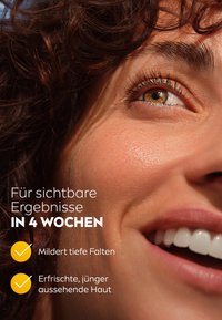 Close-up of a smiling face with brown curly hair and clear skin. Text highlights benefits of a skincare product in German.