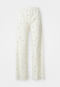Pantalones de pierna ancha color crema con cintura elástica, con lunares negros espaciados uniformemente por toda la tela.