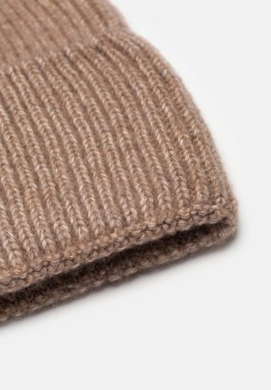 Beżowa czapka dziergana z prążkowaną teksturą, z podwiniętym mankietem i miękkim, gęstym materiałem. Zaokrąglony kształt bez widocznych wzorów czy akcentów.