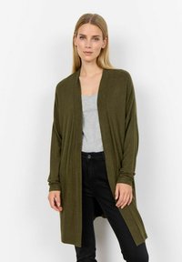 Cardigan lungo verde oliva realizzato in morbido tessuto a maglia. Presenta un design aperto e una vestibilità rilassata, con maniche lunghe e senza bottoni visibili.