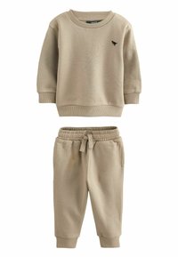 Beige Zweiteiler bestehend aus einem langärmeligen Sweatshirt mit gerippten Bündchen und passenden taillierten Jogginghosen mit elastischem Bund.