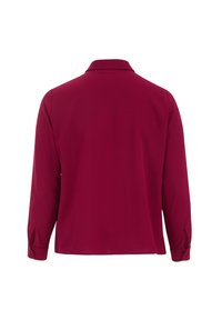 Poloko s dlouhým rukávem v tmavě burgundské barvě, s límečkem, knoflíkovými manžetami a hladkým, strukturovaným materiálem.