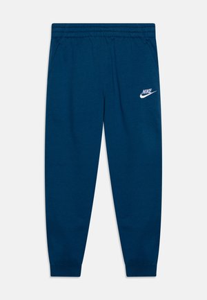 Pantalon de survêtement Nike bleu foncé avec taille et poignets élastiques, poches latérales et logo blanc Nike sur la cuisse gauche.
