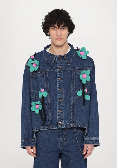 Denim jacket featuring colorful fabric flower appliqués in teal and pink. Classic collar, button front, and relaxed fit.