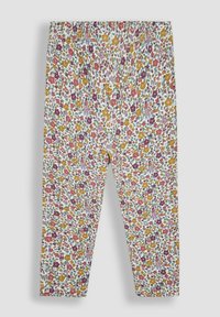 Leggings floreali con uno sfondo bianco, caratterizzati da un motivo a fiori rosa, gialli e viola con foglie verdi. Vita elastica.