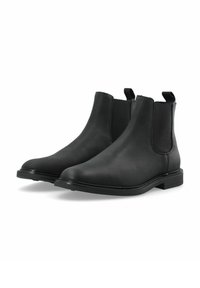 Botas Chelsea de cuero negro con paneles laterales elásticos, puntera redonda y pequeños tacones cuadrados negros. Textura suave con acentos de diseño mínimos.