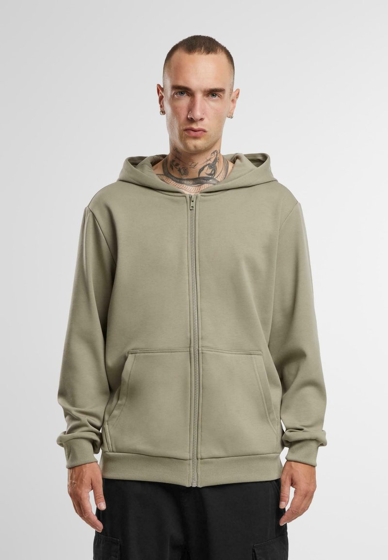 Olijfgroene rits-hoodie van zachte stof, met een ruime capuchon, zakken aan de voorkant, lange mouwen en geribde manchetten en zoom.