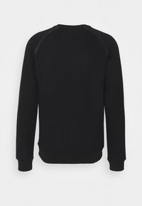 Sort crewneck-sweatshirt lavet af blødt stof med lange ærmer, ribbede manchetter og kant. Har et enkelt, ensfarvet design uden grafik.