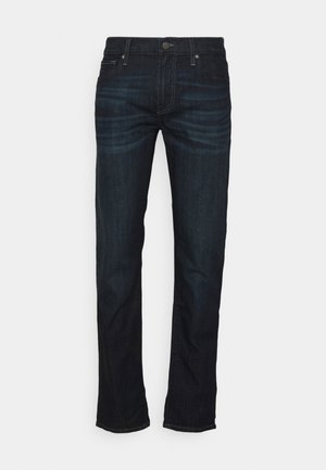 Dark blue denim jeans with a straight cut, featuring a classic five-pocket design, brass hardware, and subtle fading on the thighs.