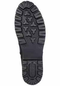Semelle en caoutchouc noire avec des crampons profonds, ornée d'un motif de papillon géométrique. Comprend le nom de la marque en relief et des indications de taille.