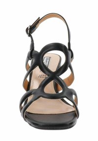 Czarne sandały na wysokim obcasie z wycięciami i zaokrąglonymi paskami. Posiadają beżową wkładkę i pasek wokół kostki z klamrą. Gładka skórzana faktura.