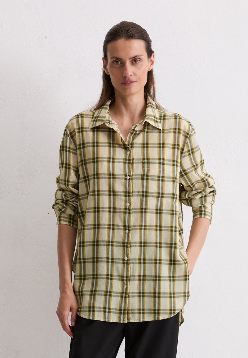 Light plaid shirt in beige, green, and yellow, featuring a button-down design, long sleeves rolled up, and a curved hem for a relaxed fit.