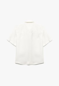 Short-sleeve white blouse made of smooth fabric, featuring a collared neckline and a rounded hemline with a subtle back seam detail.