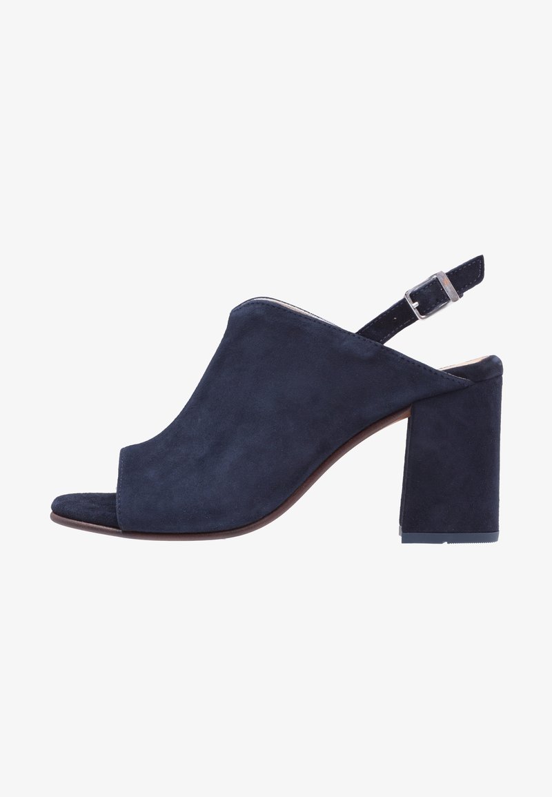 Chaussure slingback en daim bleu marine à bout ouvert, avec un talon haut épais et une bride ajustable à boucle.
