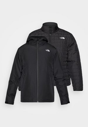 Kaksi mustaa takkia pinottuna: toinen on paksu, kirjailtu takki korkealla kauluksella; toinen on kevyt takki hupulla ja vetoketjulla.