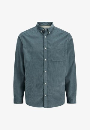 Tamsiai žalsvos spalvos kordurovė marškiniai, turintys sagomis užsegamą apykaklę, ilgomis rankovėmis ir vieną krūtinės kišenę. Tekstūruota medžiaga su vertikaliomis juostelėmis.