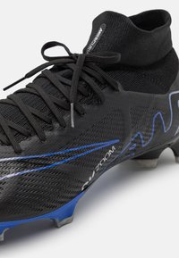 Black soccer cleat featuring a fitted ankle, textured upper, blue accent stripes, and a black lace closure for secure fit.