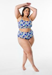 Blommönstrad bikini gjord av elastiskt tyg har en crop top med justerbara axelremmar och högmidjade bottoms, huvudsakligen i lila och gult.