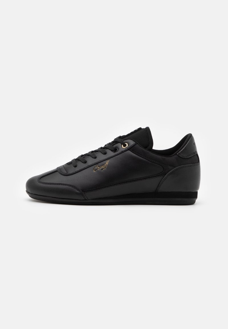 Schwarze Ledersneaker mit einem eleganten Design, runder Zehenpartie, goldenen Ösen, strukturierten seitlichen Akzenten und einem gepolsterten Kragen für zusätzlichen Komfort.