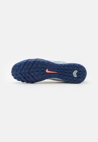 Nike running shoe sole, featuring a blue rubber base with textured grip, orange logo, and a smooth, rounded shape.