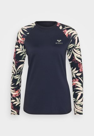 Navy long-sleeve top with floral pattern on sleeves, featuring a round neckline and Roxy logo on chest. Smooth, stretchy fabric.
