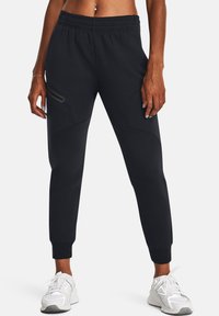 Black jogger pants made of soft, stretchy fabric. Elastic waistband, tapered cuffs, side pockets with subtle design details.